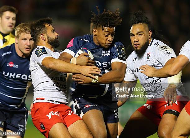Paolo Odogwu of Sale Sharks is tackled by Eric Escande and Francois Trinh-Duc of RC Toulon during the European Rugby Champions Cup match between Sale...