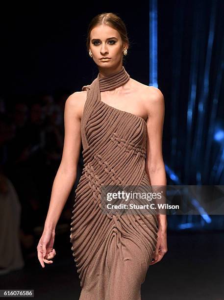 Model walks the runway at the Ezra show during Fashion Forward Spring/Summer 2017 at the Dubai Design District on October 21, 2016 in Dubai, United...