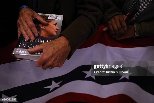 Supporter holds a book as democratic presidential nominee former Secretary of State Hillary Clinton speaks during a campaign rally at Cuyahoga...