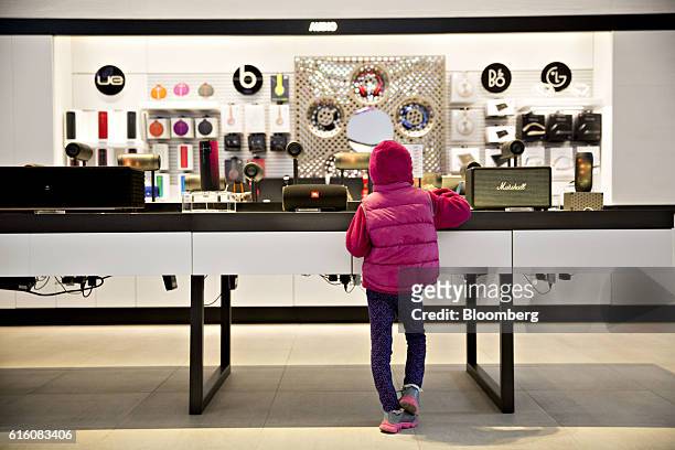 Girl looks over a display of external speakers at a T-Mobile US Inc. Store in Chicago, Illinois, U.S., on Friday, Oct. 21, 2016. T-Mobile US Inc. Is...