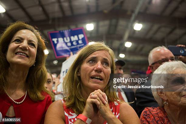 Rochelle Pasquariello, center, cries while watching Republican presidential nominee Donald Trump at a campaign rally on October 21, 2016 in Newtown,...
