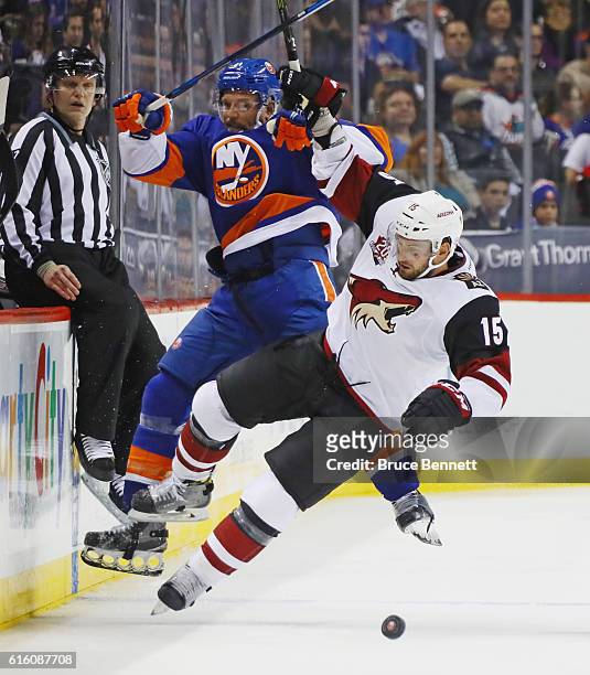 Dennis Seidenberg of the New York Islanders is hit by Brad Richardson of the Arizona Coyotes during the second period at the Barclays Center on...