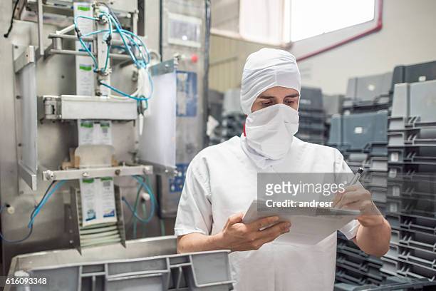 man working at a food processing plant - dairy factory stock pictures, royalty-free photos & images