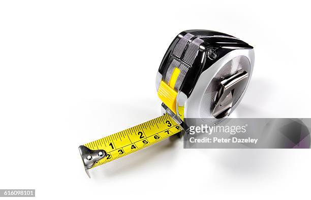 builders metal tape measure close up - mass unit of measurement stock-fotos und bilder