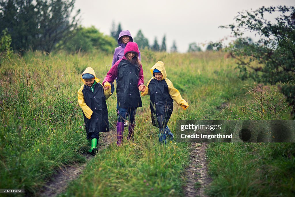 Family hiking in the rain