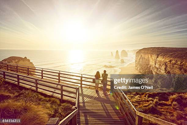tourists looking a the 12 apostles - victoria australia stock pictures, royalty-free photos & images