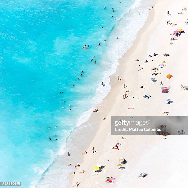 aerial view of beach crowded with tourists, greece - aerial beach stock pictures, royalty-free photos & images