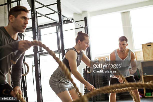 fitness people working out with battle ropes - coach stock pictures, royalty-free photos & images