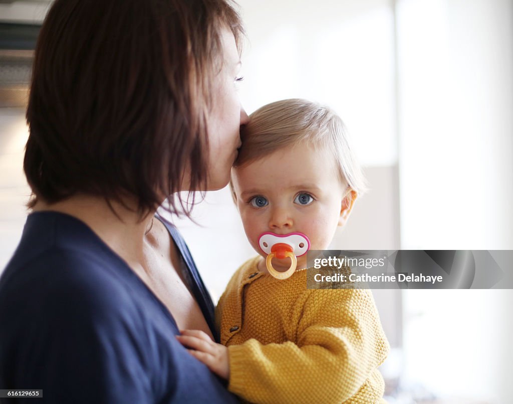 A baby girl in the arms of her mum