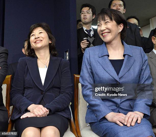 Japan - Seiko Noda and Sanae Takaichi smile during a press conference in Tokyo on Dec. 25 after they were picked as chief of the General Council and...