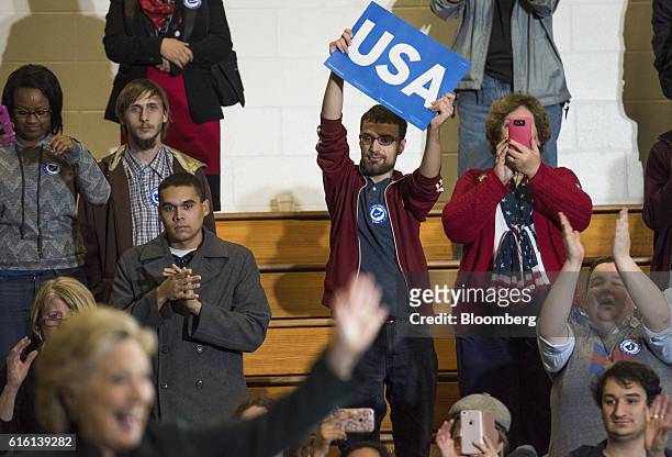 An attendee holds a campaign sign during a campaign event with Hillary Clinton, 2016 Democratic presidential nominee, in Cleveland, Ohio, U.S., on...