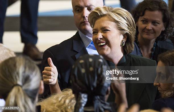 Hillary Clinton, 2016 Democratic presidential nominee, gives a thumbs up as she greets attendees during a campaign event in Cleveland, Ohio, U.S., on...