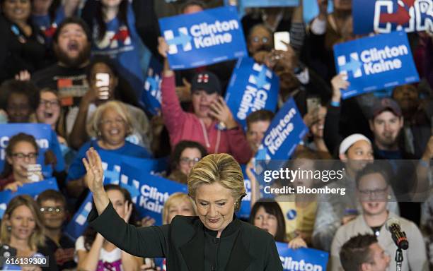 Hillary Clinton, 2016 Democratic presidential nominee, waves as she takes the stage before speaking during a campaign event in Cleveland, Ohio, U.S.,...