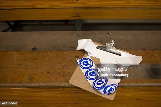 Clipboard with Ohio Voted Early stickers sits on bleachers following a campaign event with Hillary Clinton, 2016 Democratic presidential nominee, in...