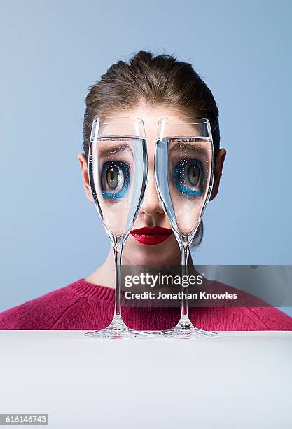 looking through champagne glasses - women wearing see through clothing stockfoto's en -beelden