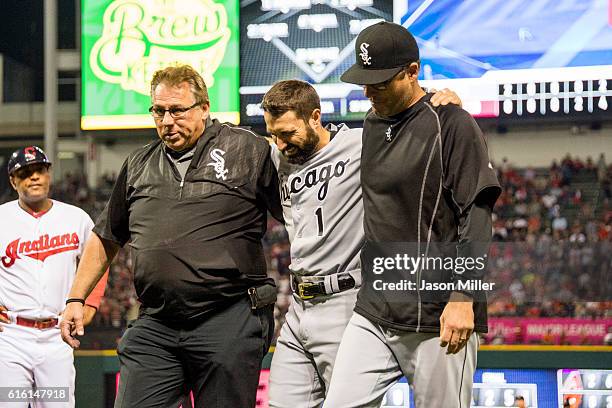 Trainer Herm Schneider and manager Robin Ventura help Adam Eaton of the Chicago White Sox off the field after Eaton hit the centerfield wall making a...