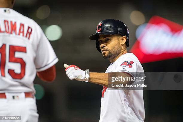 Coco Crisp celebrates with first base coach Sandy Alomar Jr. #15 of the Cleveland Indians after Crisp reaches first on an RBI single during the...