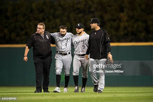 Trainer Herm Schneider outfielder Carlos Sanchez and manager Robin Ventura help Adam Eaton of the Chicago White Sox off the field after Eaton hit the...