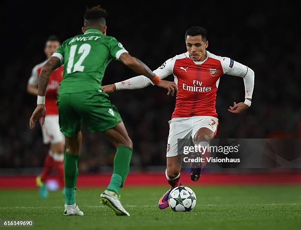 Alexis Sanchez of Arsenal takes on Anicet Abel of PFC Ludogorets Razgrad during the UEFA Champions League match between Arsenal FC and PFC Ludogorets...