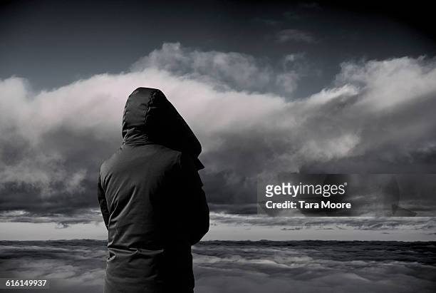 person looking at dark clouds - one man only photos stock pictures, royalty-free photos & images