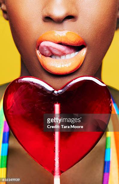 woman with heart shaped lollipop - lollipops stock pictures, royalty-free photos & images