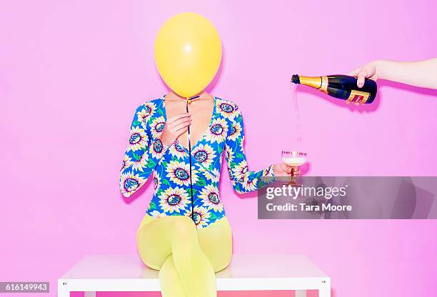 woman with balloon and champagne - multi colored shirt foto e immagini stock