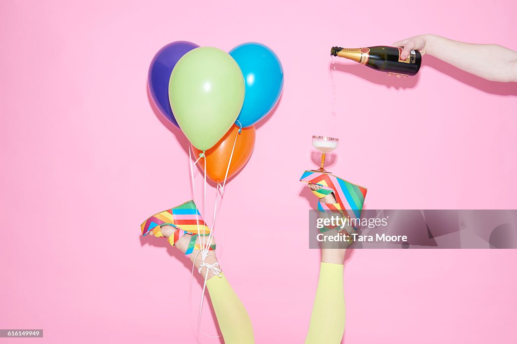 Legs with champagne and balloons