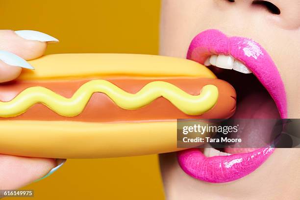 woman eating hotdog - plastic stock pictures, royalty-free photos & images