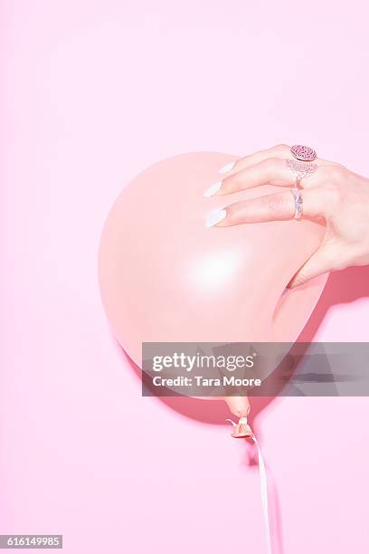 hand squeezing pink balloon - blowing up balloon bildbanksfoton och bilder