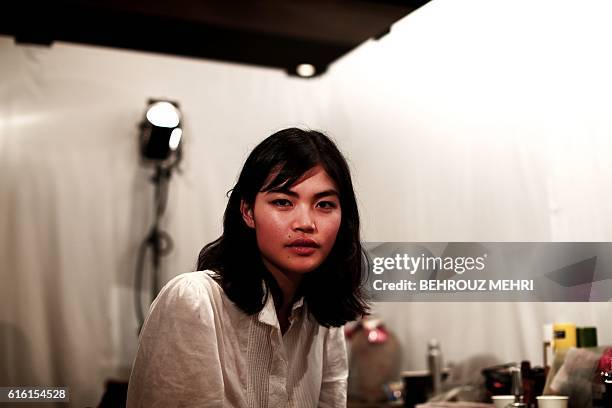 In this picture taken on October 17 Japanese model Rina Fukushi looks at the camera on in back stage before a show by Japanese designer Tae Ashida...