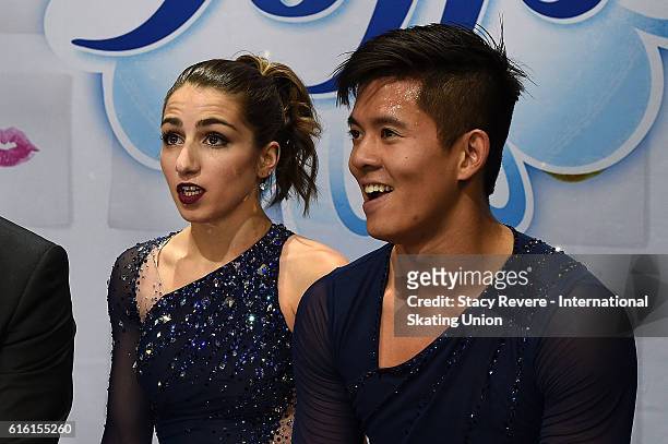 Marissa Catelli and Mervin Tran of the United States wait for their score to be announced on day 1 of the Grand Prix of Figure Skating at the Sears...