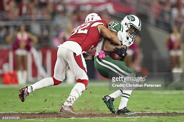 Wide receiver Charone Peake of the New York Jets is tackled by free safety Tyrann Mathieu of the Arizona Cardinals after a reception during the NFL...