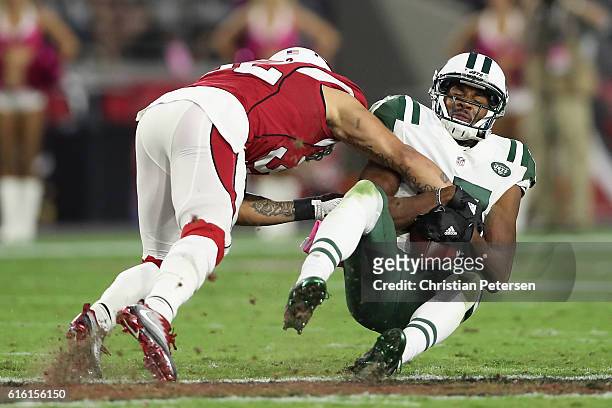 Wide receiver Charone Peake of the New York Jets is tackled by free safety Tyrann Mathieu of the Arizona Cardinals after a reception during the NFL...