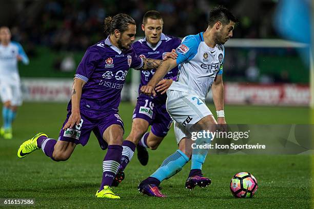 Bruno Fornaroli of Melbourne City controls the ball infant of Josh Risdon of Perth Glory and Chris Harold of Perth Glory during the 3rd Round of the...