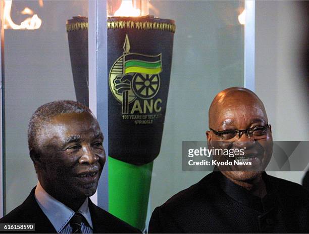 South Africa - South African President Jacob Zuma and former President Thabo Mbeki smile -- at a church in Bloemfontein, South Africa, in the early...