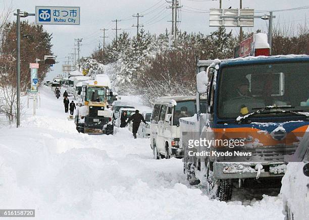 Mutsu, Japan - Photo shows vehicles stranded in heavy snow on Route 279 in Aomori Prefecture, northeastern Japan, at 8:15 a.m. On Feb. 2, 2012.