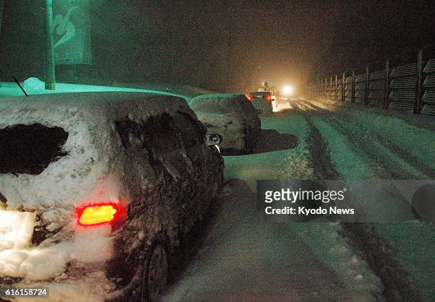 Mutsu, Japan - Photo shows cars stranded on a snowy road in Mutsu, Aomori Prefecture, northeastern Japan, on the evening of Feb. 1, 2012.