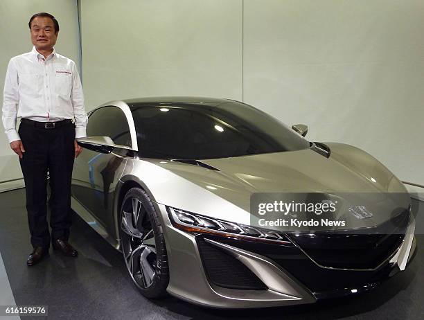 Japan - Honda Motor Co. President Takanobu Ito stands by the carmaker's NSX hybrid concept car at the company's head office in Tokyo on Feb. 3, 2012.