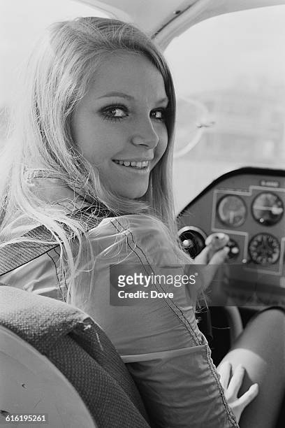 Austrian actress Eva Rueber-Staier, winner of the Miss World 1969 beauty contest, during a flying lesson at Biggin Hill in south London, 1971. Her...