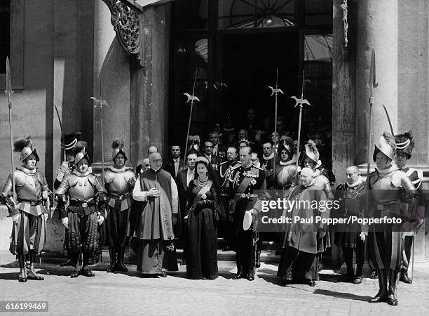 Queen Elizabeth II and Prince Philip, Duke of Edinburgh are escorted by a retinue of Swiss Guards as they leave St Peter's Basilica in the Vatican...