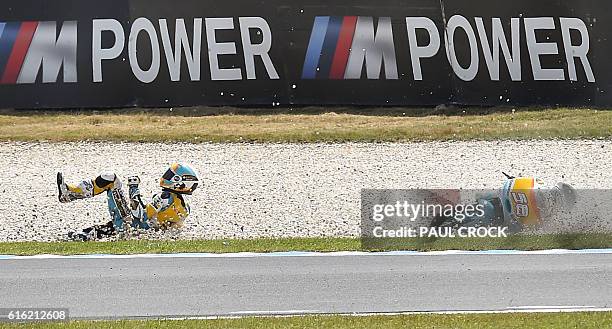 Racing Team's Spanish rider Juanfran Guevara crashes during the qualifying session of the Moto3 class at the Australian Grand Prix at Phillip Island...