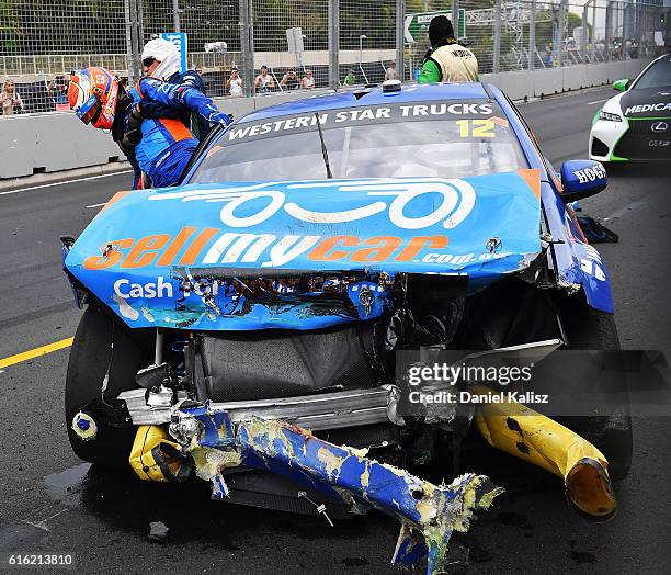 Fabian Coulthard driver of the DJR Team Penske Ford Falcon FGX is helped from his car by medical staff after having a collision with Garth Tander...