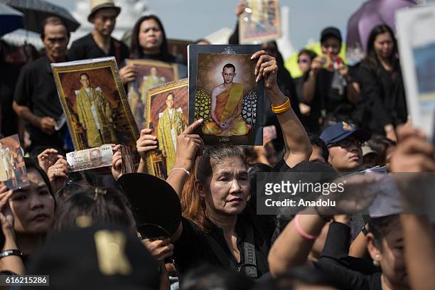 Mourners dressed in black gather around the Grand Palace as they wait to perform the Royal Anthem at Sanam Luang in Bangkok, Thailand on October 22,...