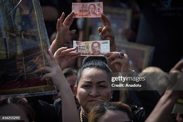 Mourners dressed in black gather around the Grand Palace as they wait to perform the Royal Anthem at Sanam Luang in Bangkok, Thailand on October 22,...