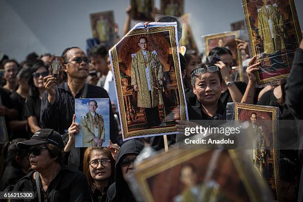 Mourners dressed in black gather around the Grand Palace as they wait to perform the Royal Anthem at Sanam Luang in Bangkok, Thailand on October 22,...