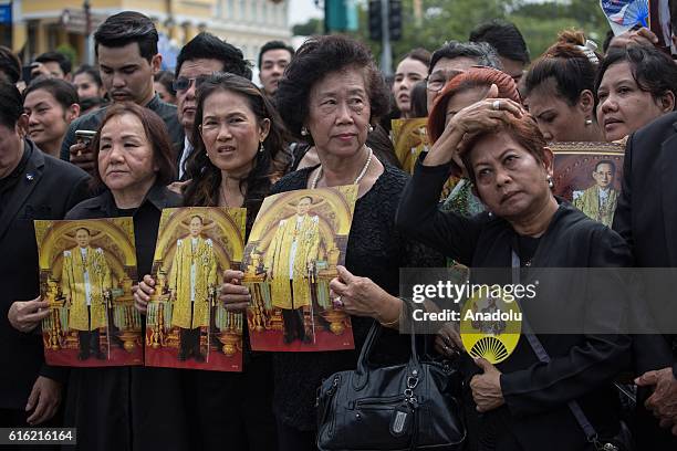 Mourners dressed in black gather around the Grand Palace as they wait to perform the Royal Anthem at Sanam Luang in Bangkok, Thailand on October 22,...