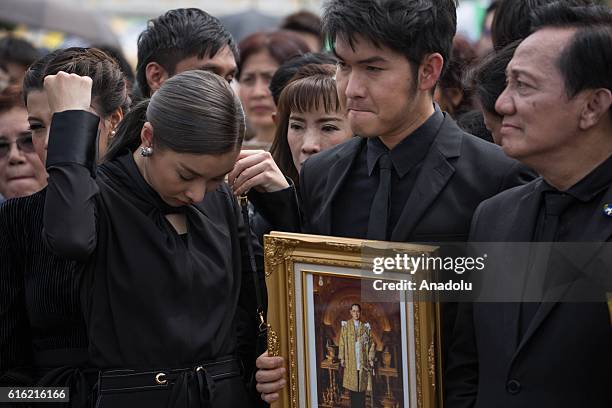 Mourners dressed in black gather around the Grand Palace as they wait to perform the Royal Anthem at Sanam Luang in Bangkok, Thailand on October 22,...