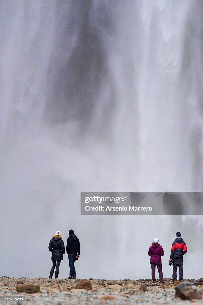 Iceland waterfall with four people