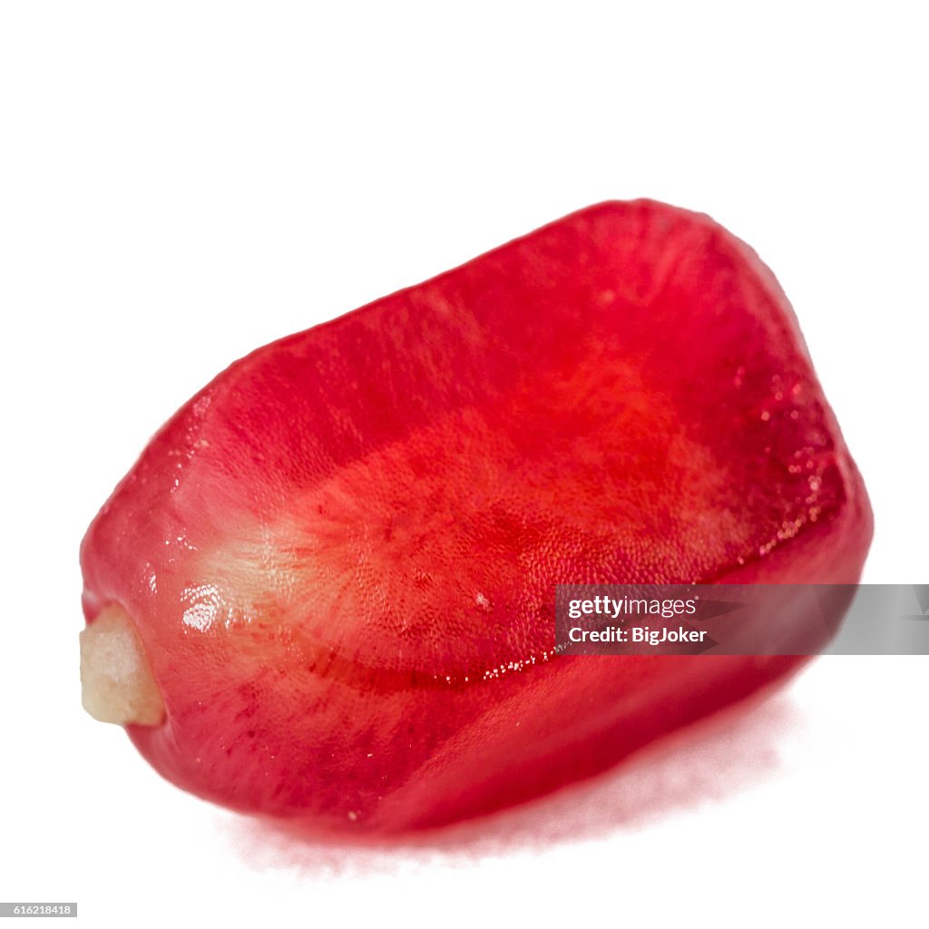 Ripe pomegranate seeds, isolated on white background