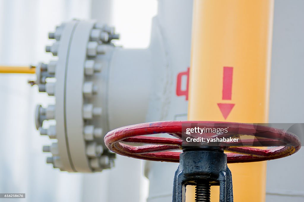 Red faucet with steel pipe in natural gas treatment plant